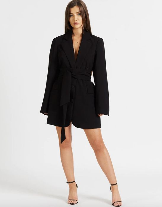 Model posing in the chic blazer dress.