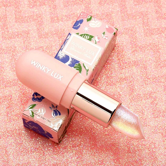 The lip balm in a sparkling light pink hue.