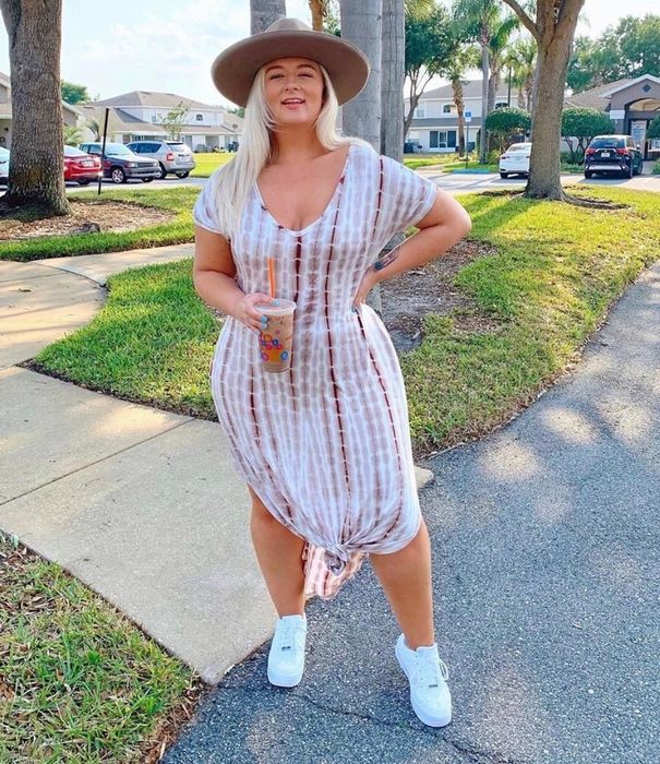 Reviewer in a white dress