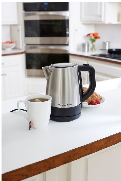 An electric kettle resting on a table, ready for use.