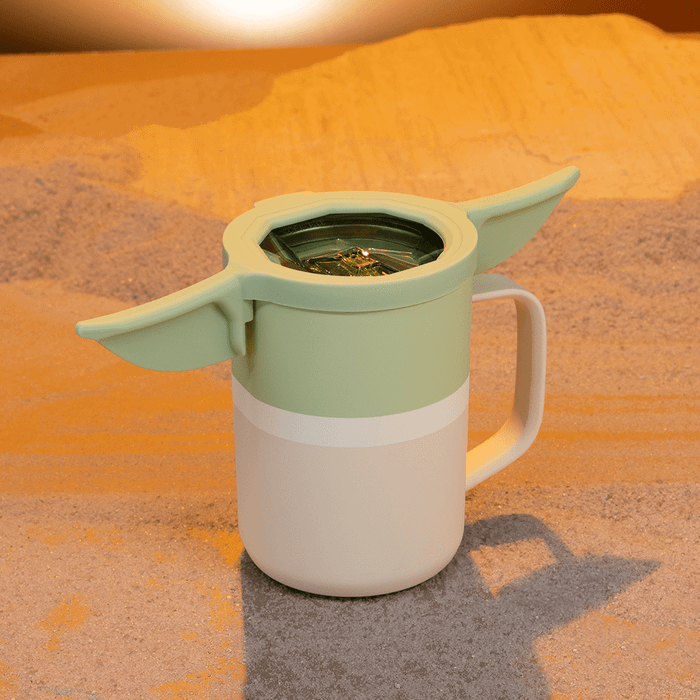 An insulated coffee mug with a lid designed to look like Yoda's ears.