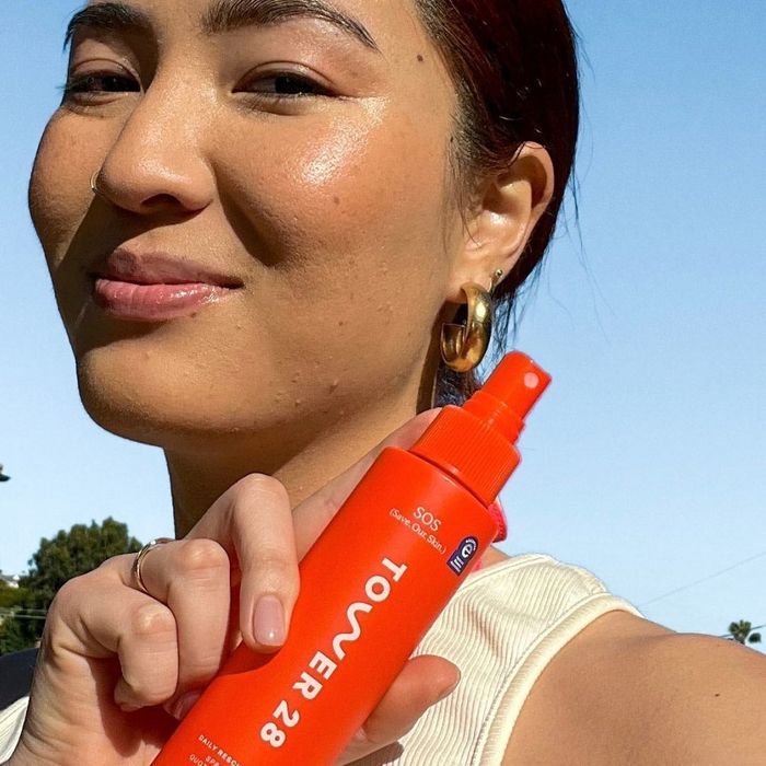 Model holding the facial spray bottle