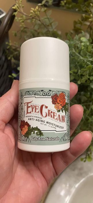 The reviewer is holding the bottle of eye cream.