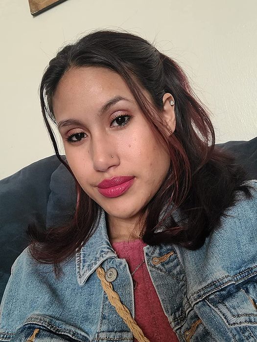 The reviewer is wearing a fuchsia matte lipstick.