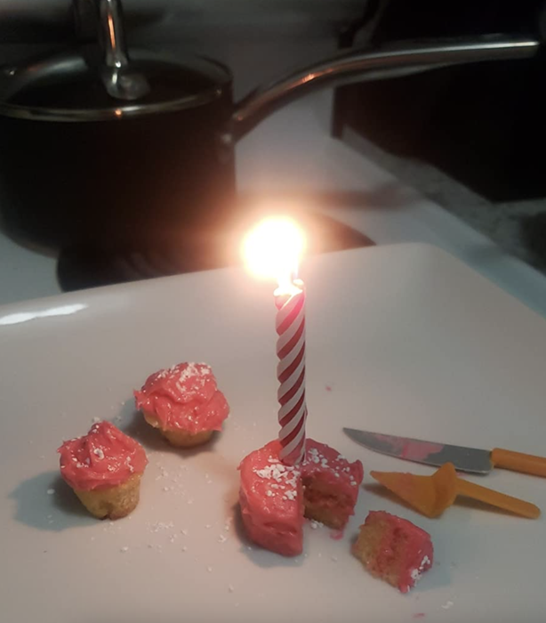 reviewer image of a tiny cake baked using a regular-sized candle, making it look massive