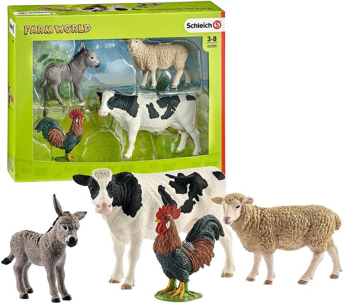 Toy figures of a donkey, cow, rooster, and sheep for children
