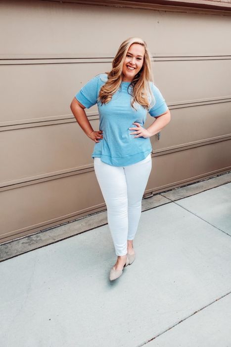 A reviewer showing off the top in a soft light blue.