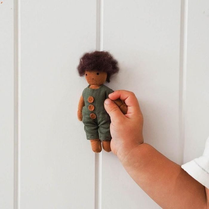 A collection of soft dolls with various hairstyles and skin tones