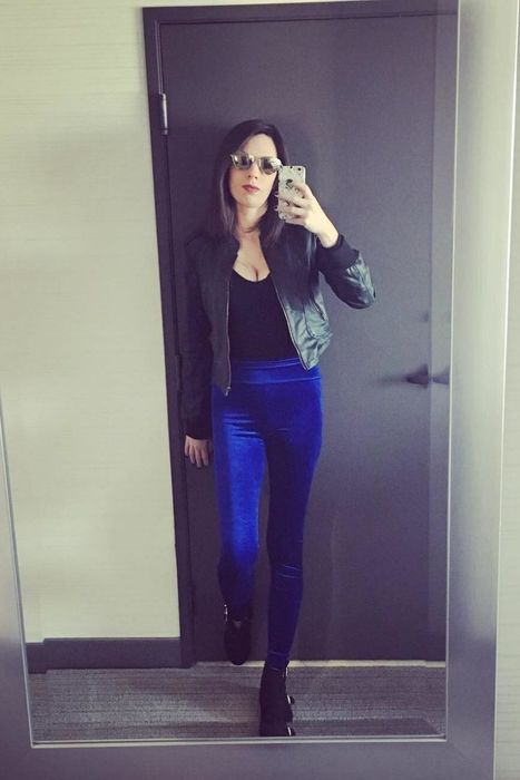 Another reviewer is seen wearing the velvet leggings in a stunning blue shade.