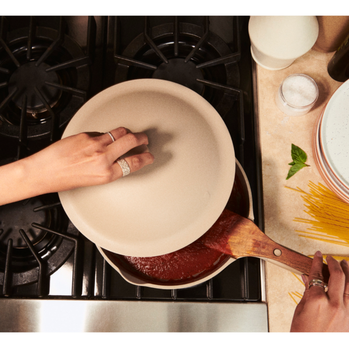 A person demonstrating the use of the pan, showcasing its functionality.