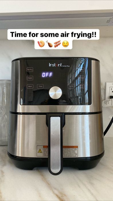 The stainless steel and black air fryer in action.