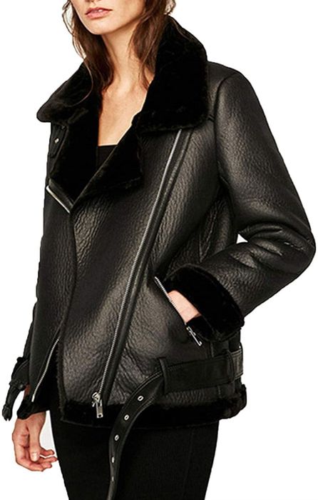 A model wearing the sleek black faux-shearling moto jacket.