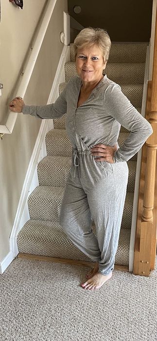 Another reviewer wears the jumpsuit in a sleek grey color.
