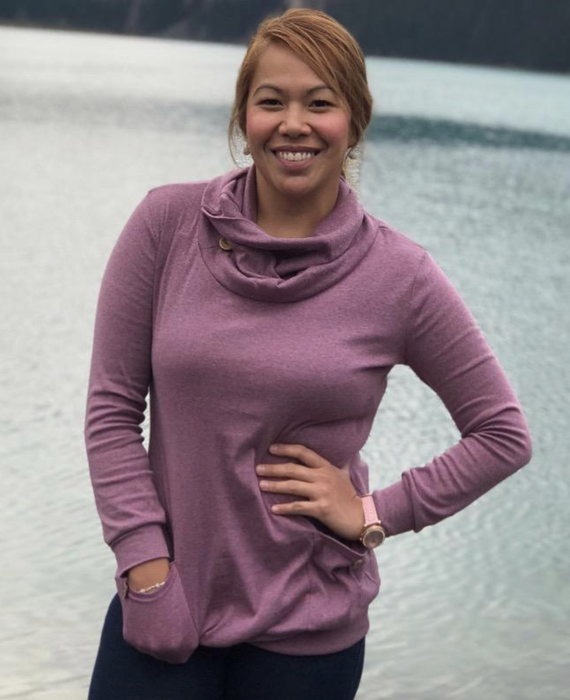 The reviewer is seen sporting a stylish purple sweater.