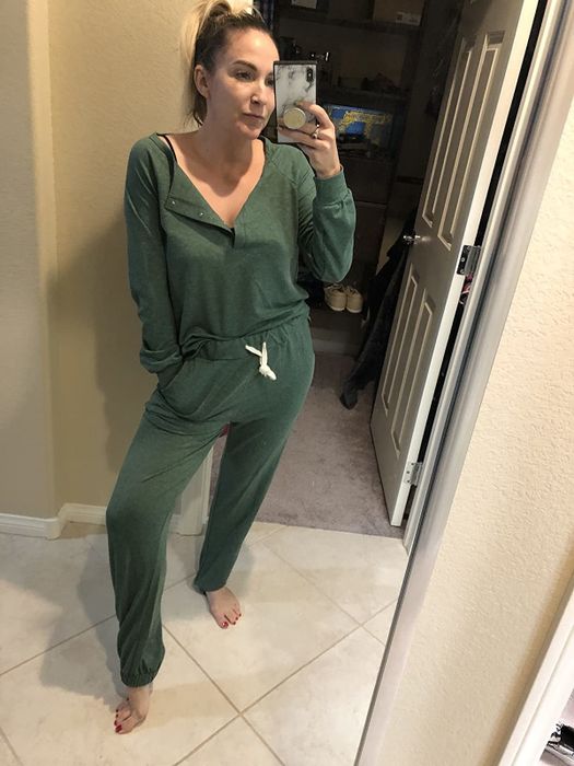 A reviewer shows off the long-sleeved sweatsuit in a fresh green shade.