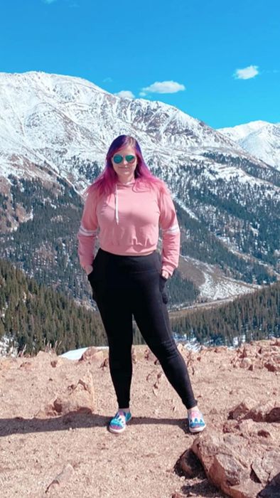 a reviewer styling the hoodie in pink