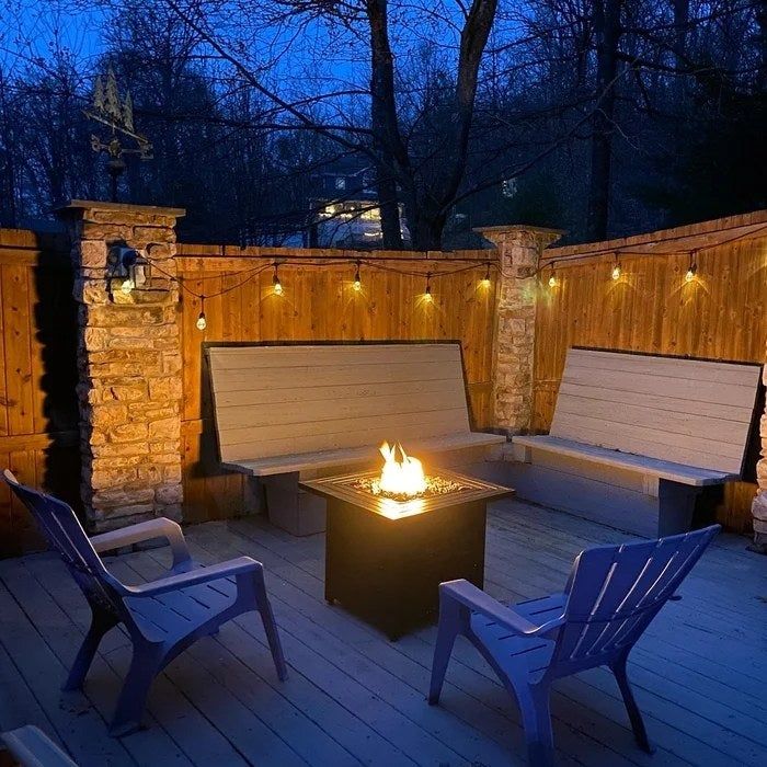 Reviewer's photo of the fire table, lit up at night.