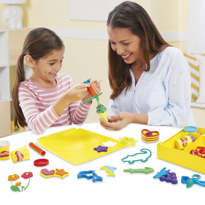 A parent and child enjoying Play-Doh together.