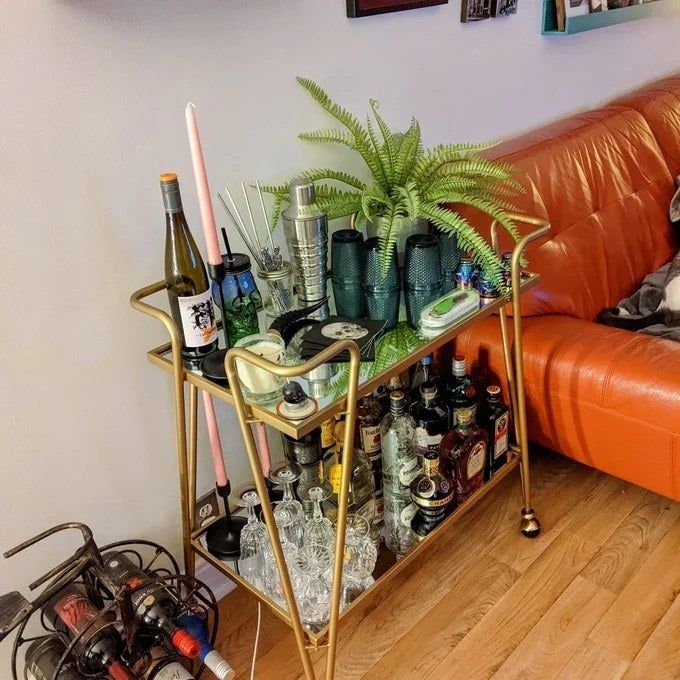 Reviewer's photo of the bar cart in Rustic Gold