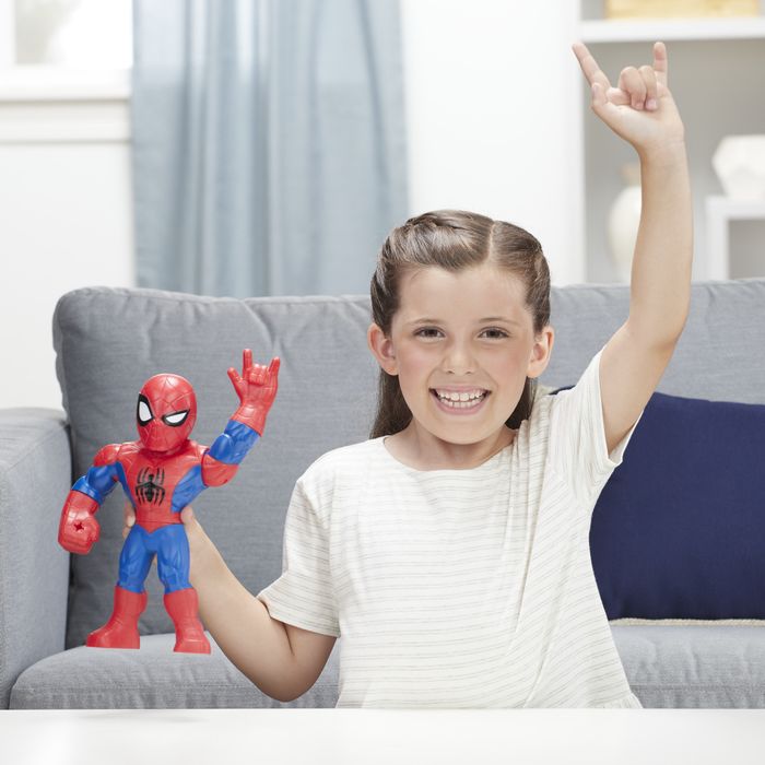 A child mimicking a Spider-Man action figure, raising both their left hands in the air while making the web-shooting gesture.