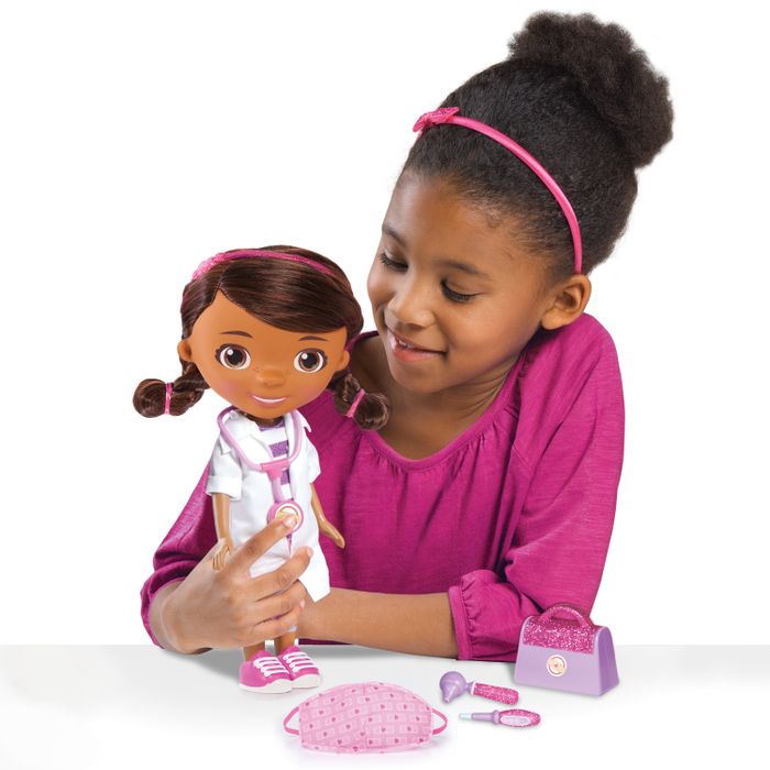 A child enjoying playtime with a Doc McStuffins doll and accessories.