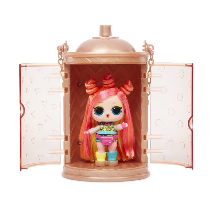 An LOL! Surprise doll with pink hair accented by orange highlights, along with colorful accessories. The doll is tucked inside a capsule-shaped case.