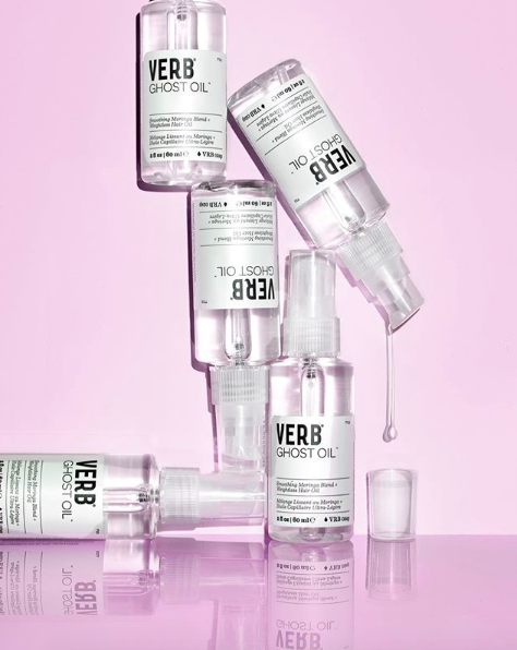 A stack of clear hair oil bottles