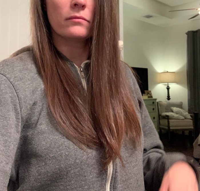 The same reviewer now showing off her smooth, straight hair after using the brush