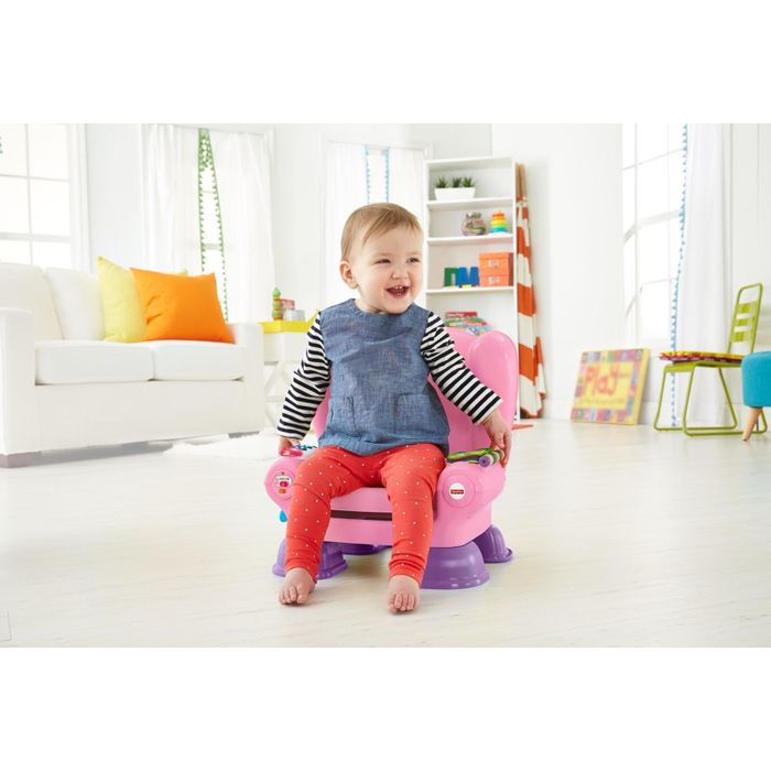 A baby enjoying the Fisher-Price play chair, sitting comfortably as they explore the features.