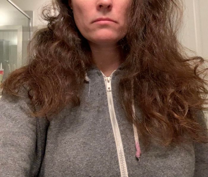 A reviewer displaying her naturally curly hair