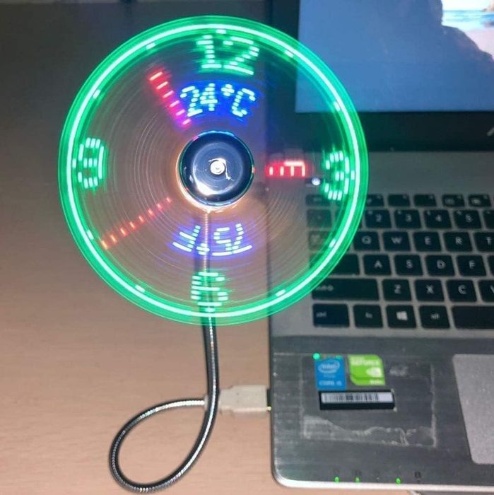 A USB fan with LED lights that shows the temperature and time when plugged into a laptop.