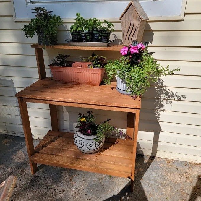 Reviewer's photo of the potting bench being used as a stylish plant stand.