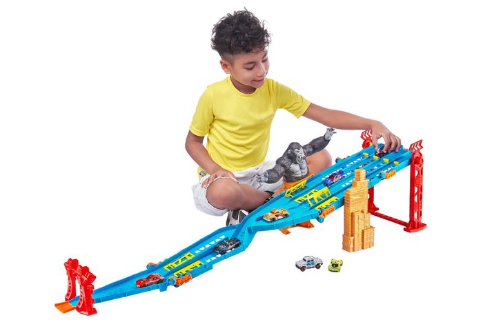 A child enjoying a race with cars on a thrilling car racing track.
