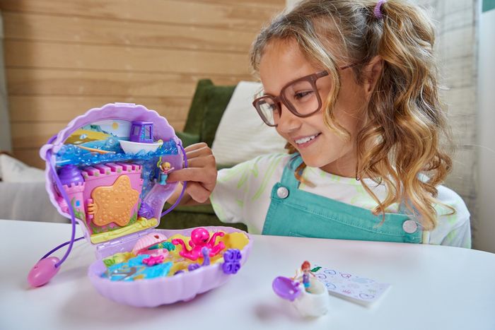 A child having fun with the Polly Pocket seashell set.