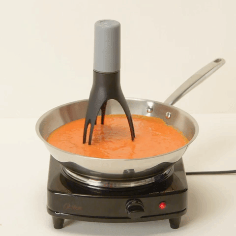 A gif showing the pan stirrer in action, stirring a sauce in a pan.