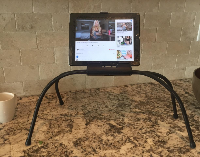 The stand placed on a countertop, holding a tablet in place.