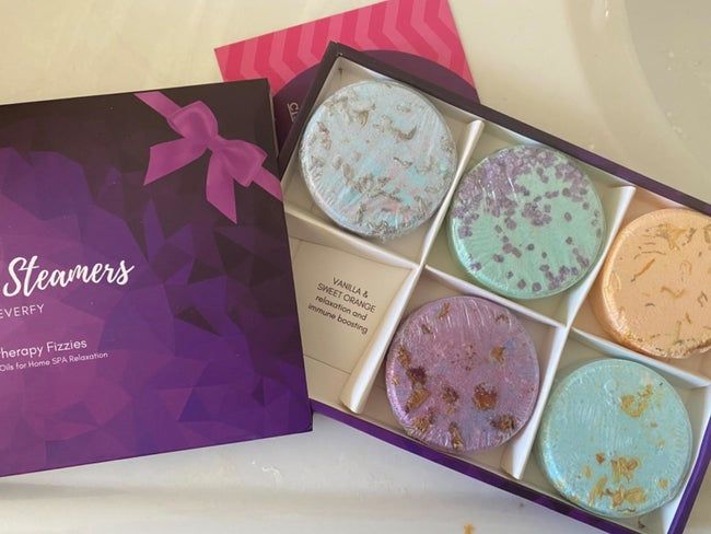 A reviewer's image showcasing shower steamers inside their original packaging.