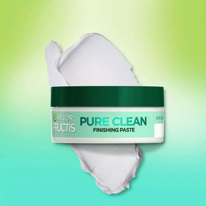 A jar of Garnier Fructis Pure Clean Finishing Paste, with a smear of the product placed behind it, featured in a shopping article