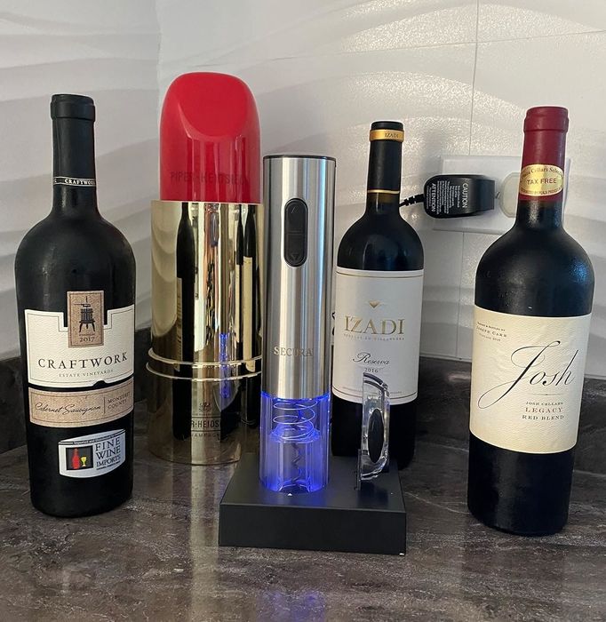 The wine opener surrounded by bottles of wine