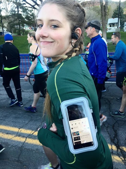 The reviewer is wearing a light blue armband while running a marathon.