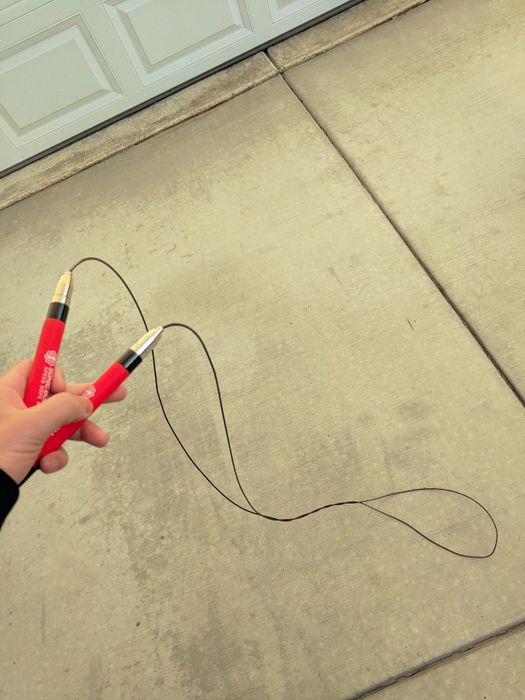 Reviewer holds a red jump rope in their hands, ready to complete a workout.