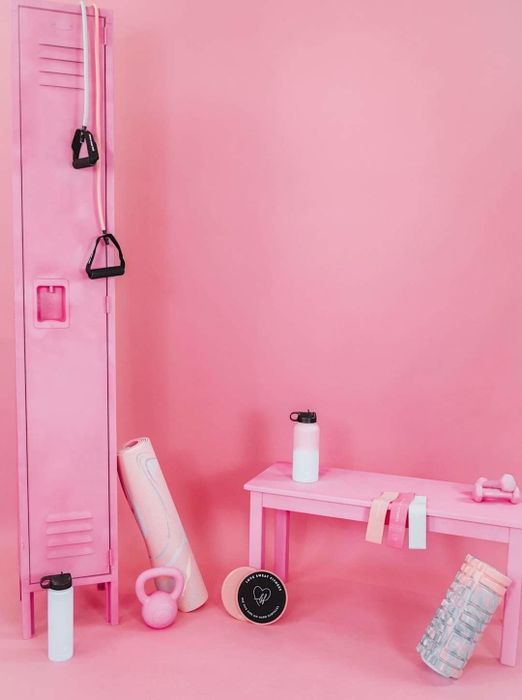 The Workout Essentials Package displayed in a pink gym setting, showcasing its sleek design and fitness functionality.