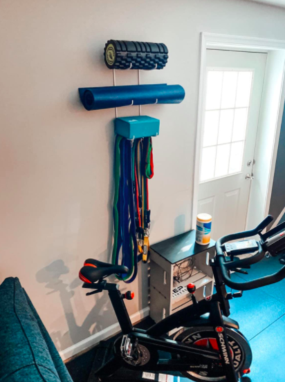 The reviewer uses the same wall mount to hang yoga mats and a foam roller, keeping their home gym organized and functional.