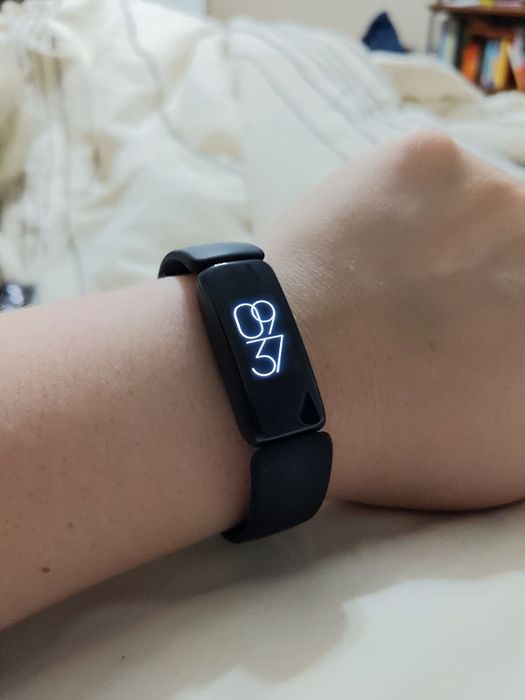 Photo of the reviewer wearing a black Fitbit
