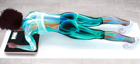 Model assumes a plank position while using an interactive Plankboard on the floor.