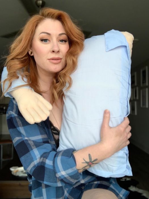 A reviewer striking a pose with a pillow