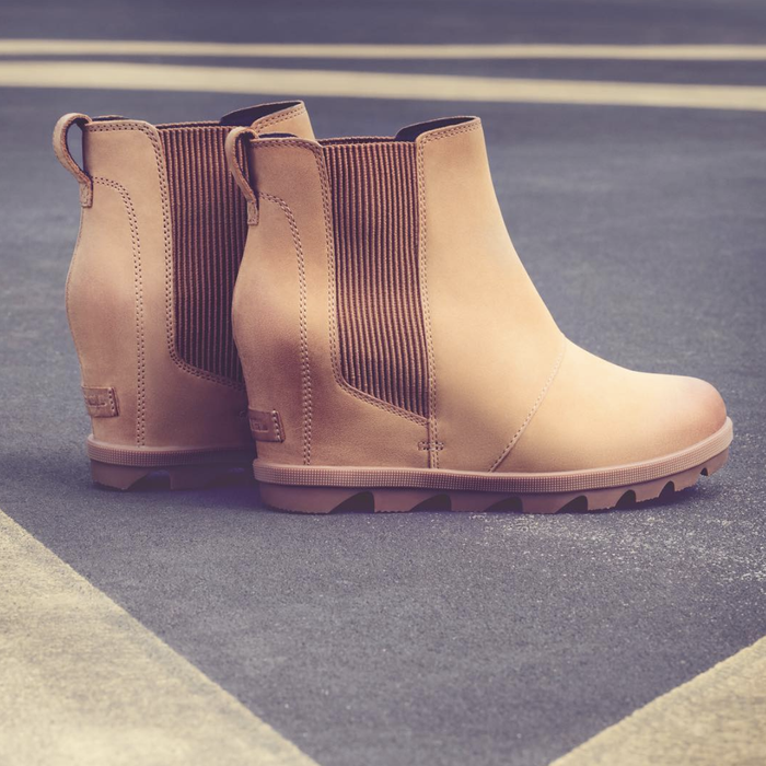 The wedge bootie with elastic side panels in a soft light brown shade.