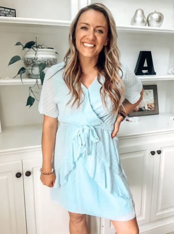 A reviewer wearing the same dress in a soft pale blue shade.