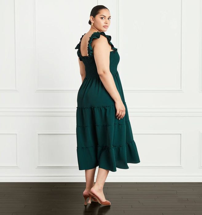 A model wearing a beautiful crepe green nap dress.