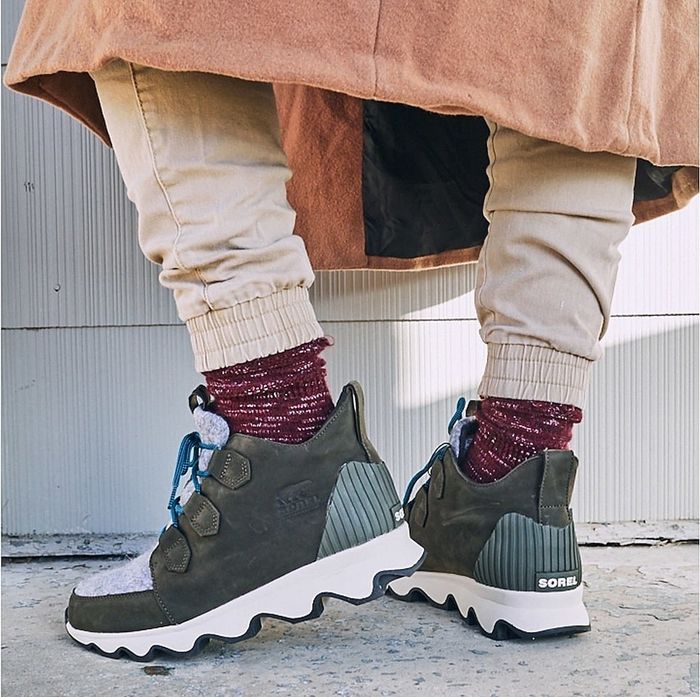 The sneaker-inspired shoe featuring a white sole, olive green sides, light grey front, and blue laces.